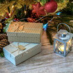 Two Christmas gifts underneath a Christmas tree